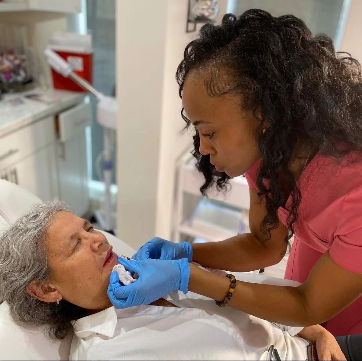 Brenda Uhunmwagho placing lip filler for a client at the Houston studio
